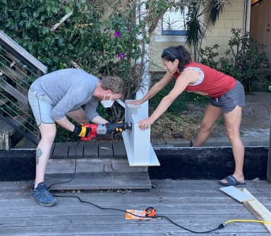 Erik and Ariana unsafely operating a power saw